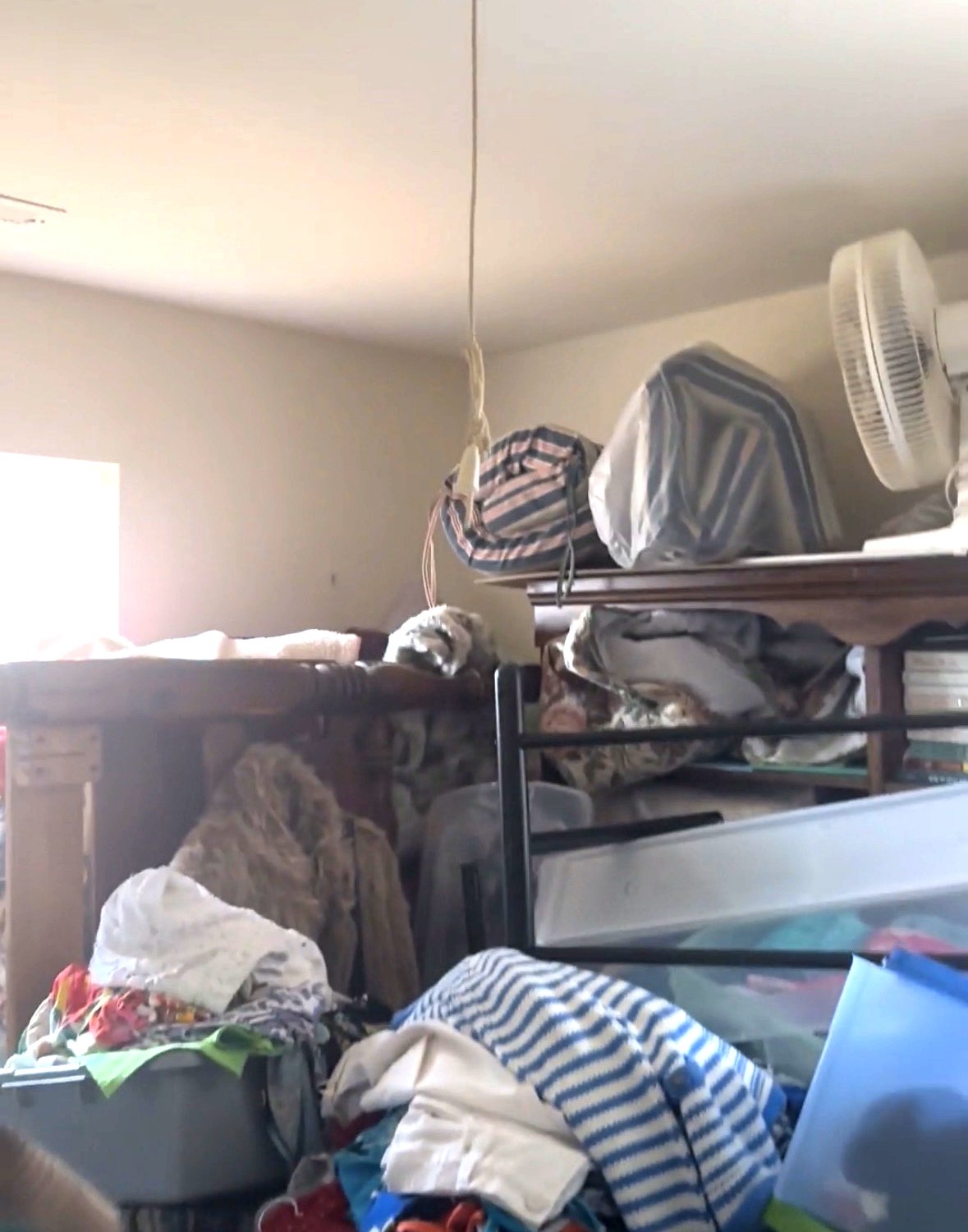 Hoarding cleanout — bedroom packed with clothing and personal items in Charlottesville VA