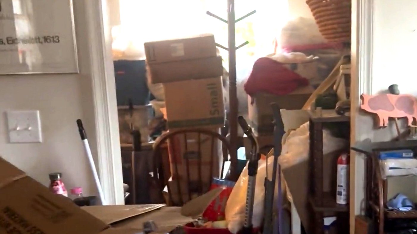 Hoarding cleanout — packed hallway with boxes in Charlottesville VA home before Albemarle Moving crew